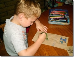 Son decorating popcorn bag.