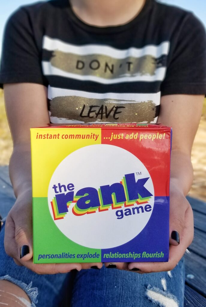 Girl holding The Rank Game box