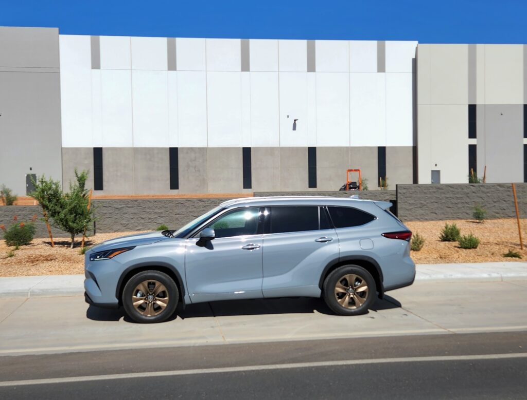 2022 Toyota Highlander Hybrid parked in front of a warehouse #celebratingtoyota