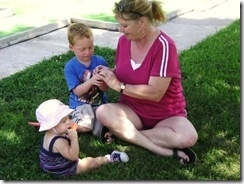 My mom and kiddos whistling through blades of grass.